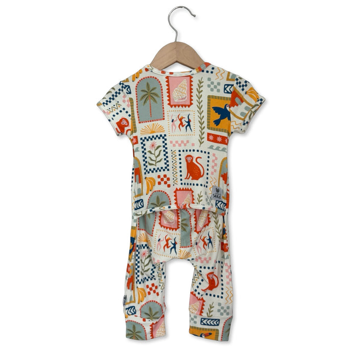 Baby romper with colorful pattern on a hanger against a white background
