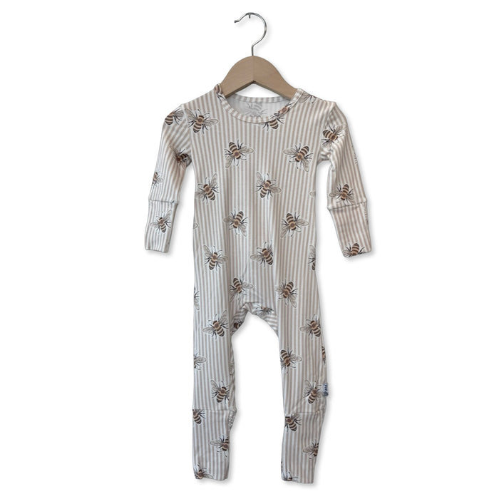 Children's onesie with bee pattern on a hanger against a white background