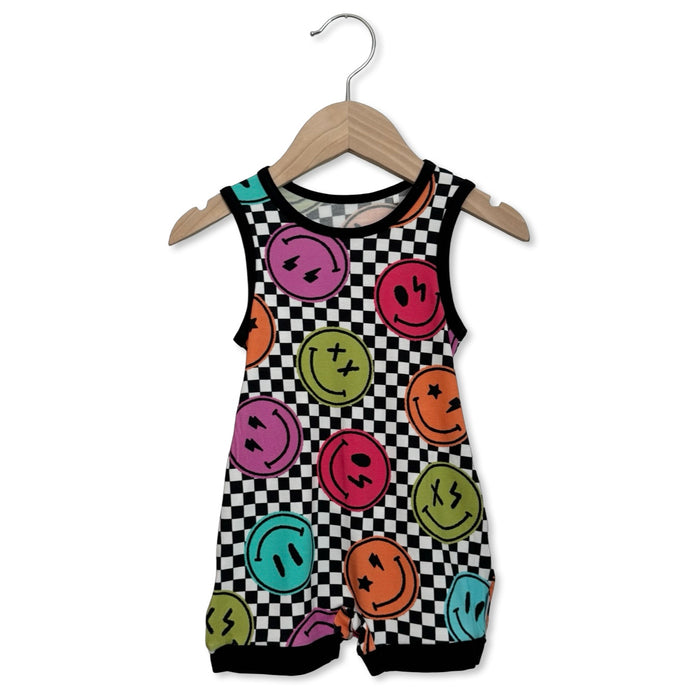 Children's sleeveless romper with smiley face pattern on a hanger against a white background