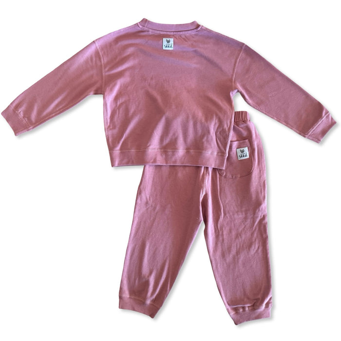 Pink children's pajama set on a white background