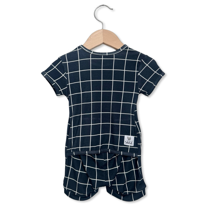 Children's navy blue and white checkered outfit on a hanger with a white background