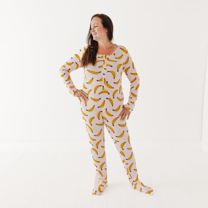 Woman wearing a banana-patterned onesie on a white background