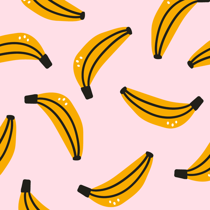 Pattern of yellow bananas with black stems on a pink background