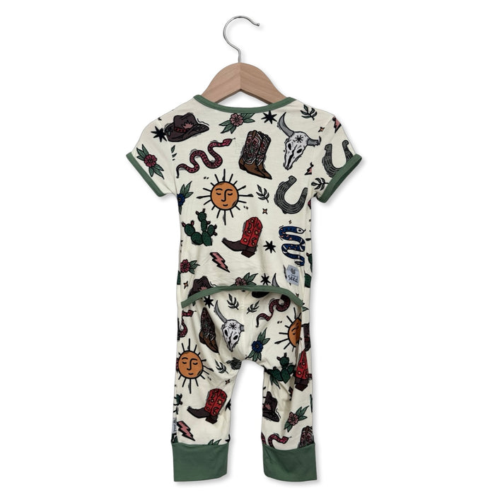 Children's onesie with cowboy-themed design on a hanger against a white background