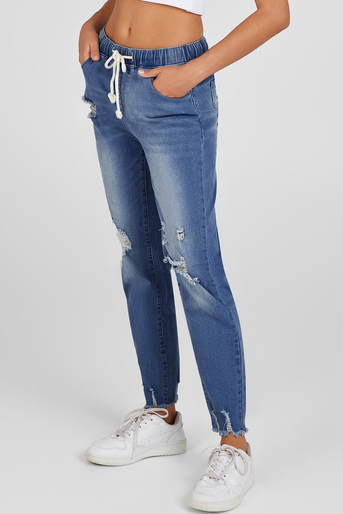 Jean bleu foncé à taille élastique, jambe droite, ourlet brut détruit