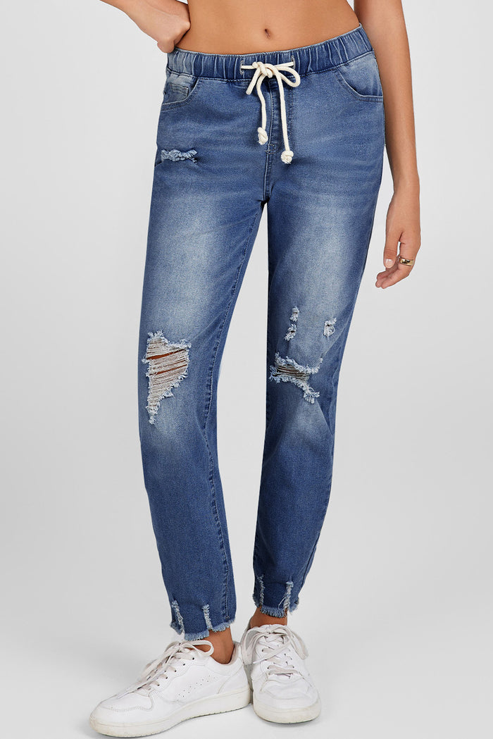 Jean bleu foncé à taille élastique, jambe droite, ourlet brut détruit
