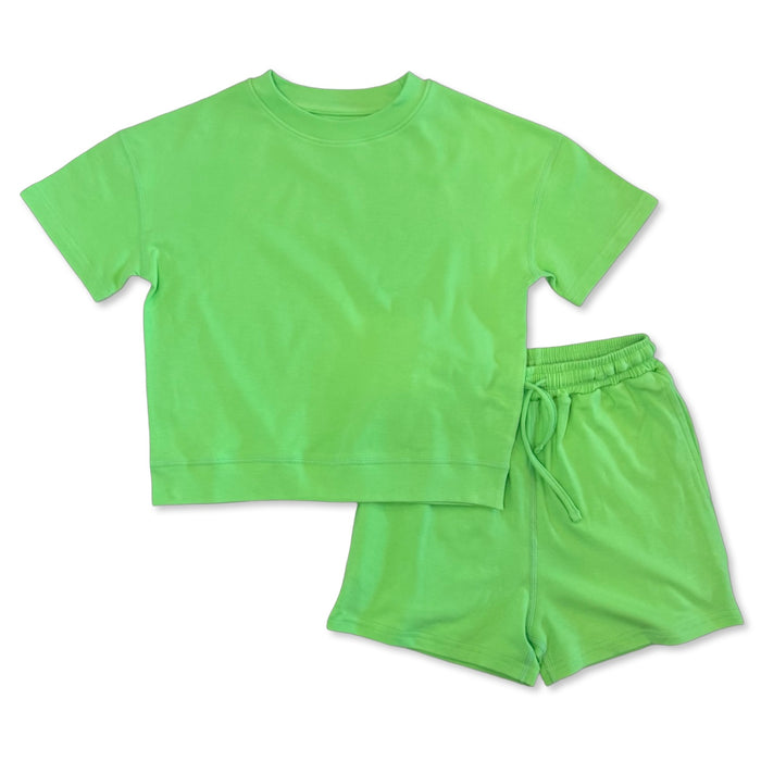 Green t-shirt and shorts set on a white background