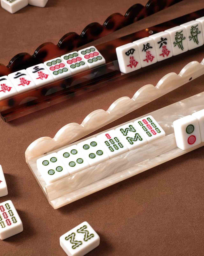 Pearl acrylic mahjong racks with scalloped holders and tile sets on board
