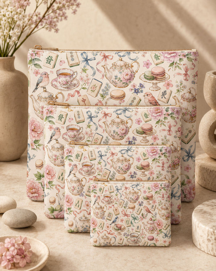 Tea-themed vegan leather zip pouch set with gold zipper; floral teapot and macarons print.