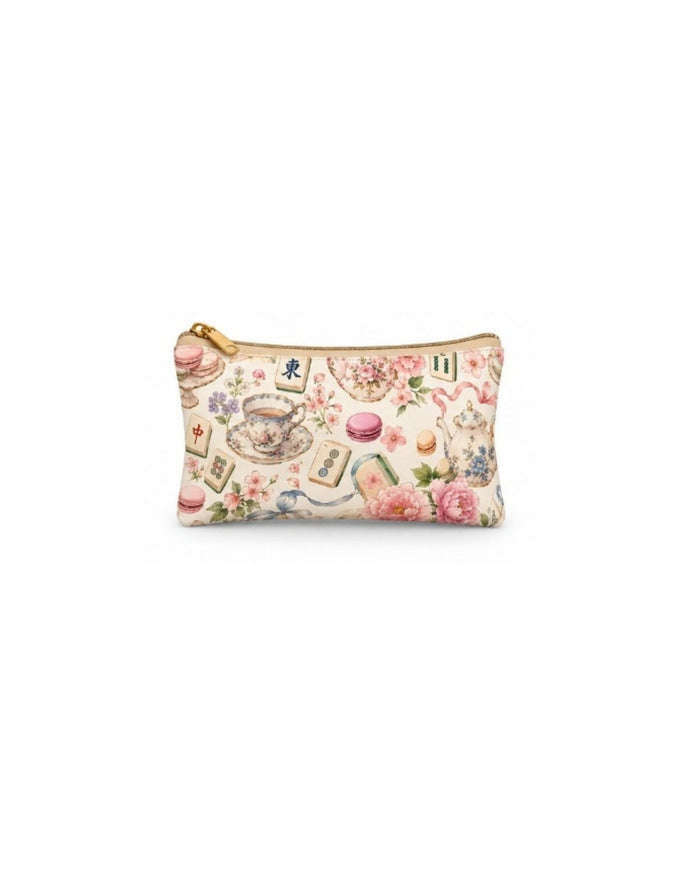 Small tea-themed zip pouch with gold zipper and pastel teacups, flowers, and macarons print.