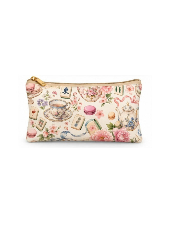 Tea-themed zip pouch with gold zipper; pastel teapot, flowers, and macarons pattern.