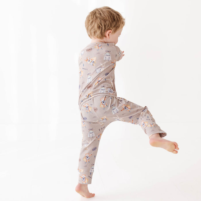 Child wearing a patterned onesie on a white background