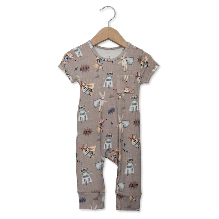 Children's romper with animal pattern on a hanger against a white background