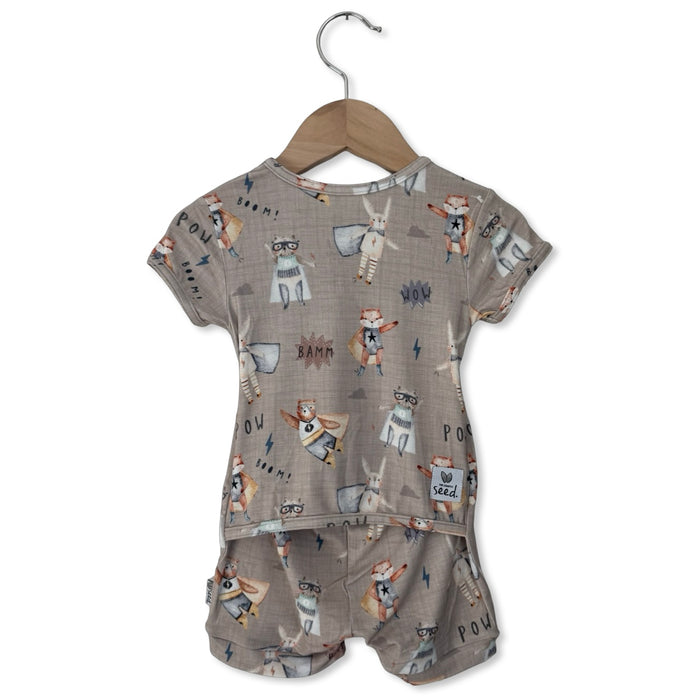 Children's outfit with patterned top and shorts on a hanger against a white background