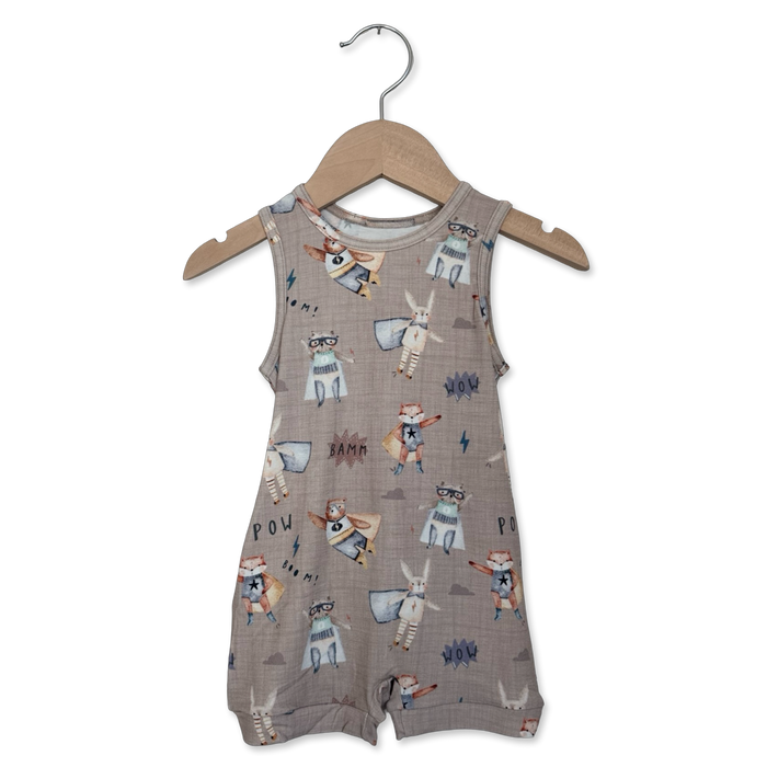 Baby romper with animal print on a hanger against a white background