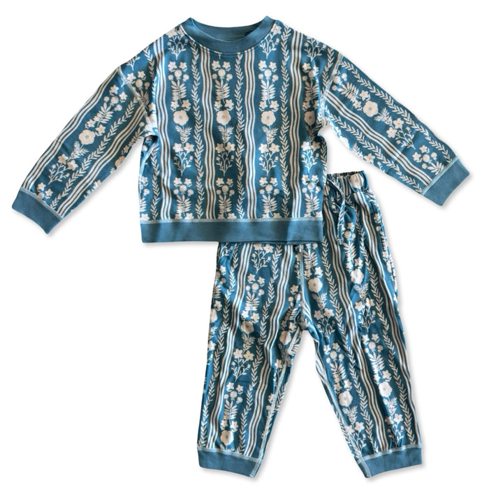 Children's pajama set with floral and stripe pattern on a white background